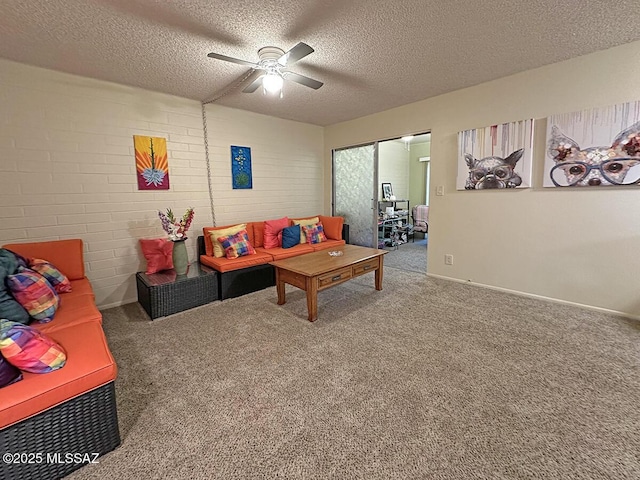 living room with ceiling fan, carpet flooring, and a textured ceiling