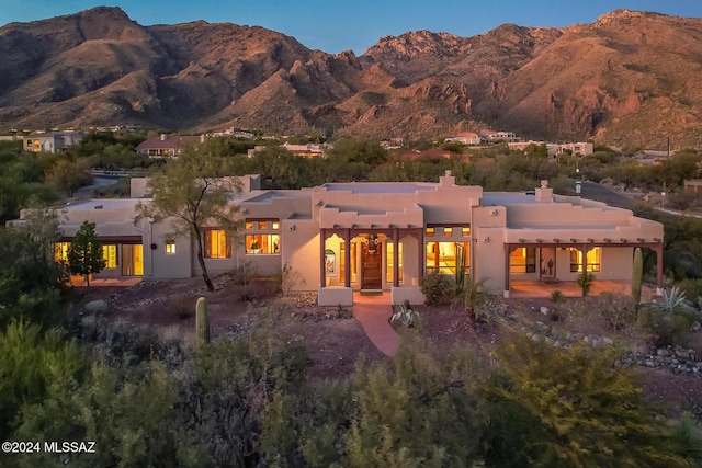 back of house with a mountain view