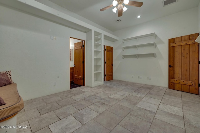 spare room featuring built in features and ceiling fan