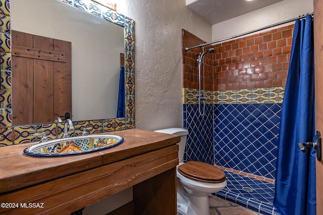 bathroom with vanity, a shower with shower curtain, and toilet