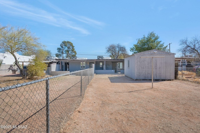 view of front of home featuring fence private yard, a storage shed, and an outdoor structure