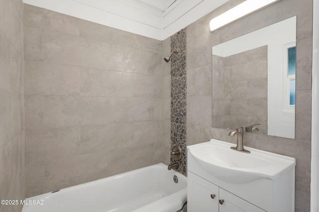 bathroom featuring washtub / shower combination and vanity