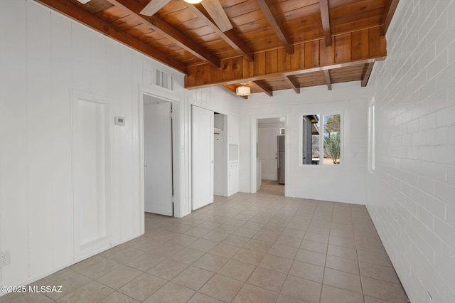 empty room featuring beamed ceiling, wooden ceiling, and light tile patterned flooring