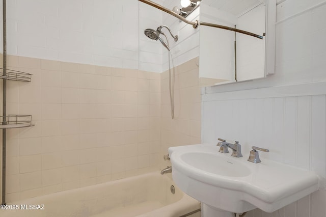 bathroom featuring tub / shower combination and a sink