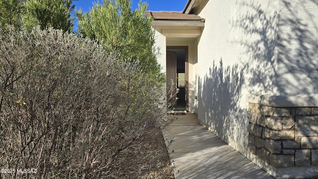 doorway to property with stucco siding