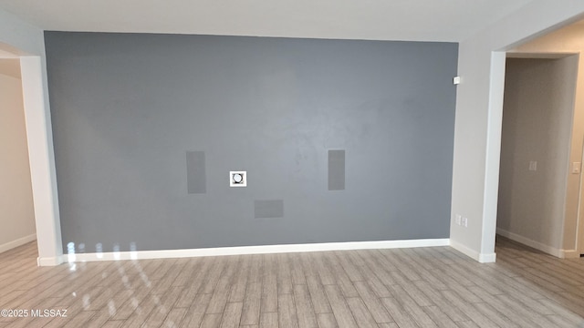 empty room featuring baseboards and wood finished floors