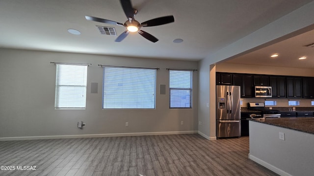 kitchen with plenty of natural light, visible vents, ceiling fan, stainless steel appliances, and wood finished floors