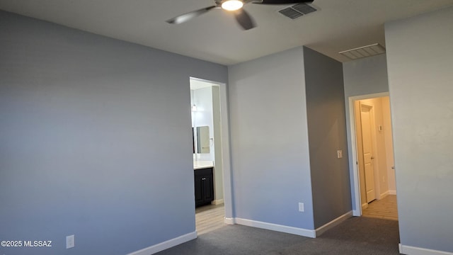 carpeted empty room featuring ceiling fan, baseboards, and visible vents