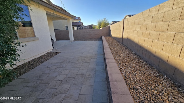 view of property exterior featuring a fenced backyard, stucco siding, and a patio area