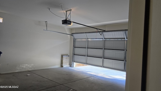 garage with baseboards and a garage door opener