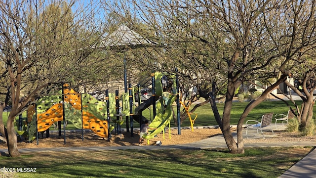 view of property's community with a yard and playground community