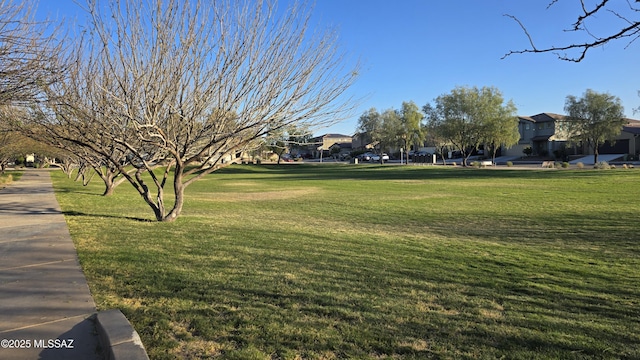 view of property's community with a residential view and a lawn