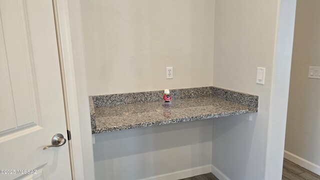bathroom with baseboards and wood finished floors