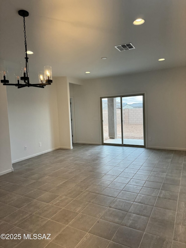 tiled spare room with an inviting chandelier