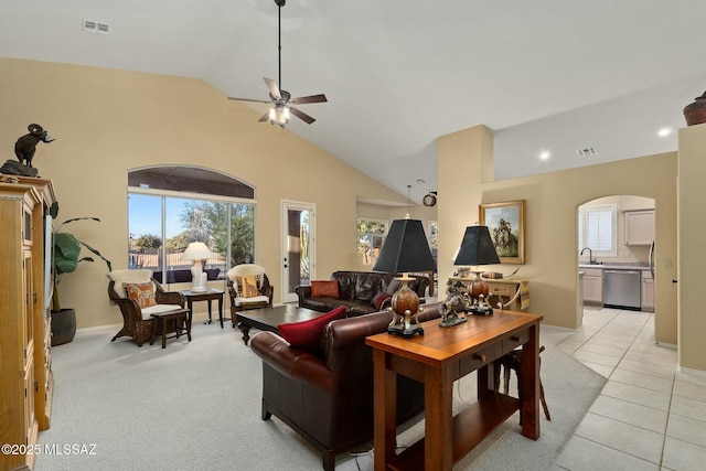 living room with high vaulted ceiling, light tile patterned floors, sink, and ceiling fan