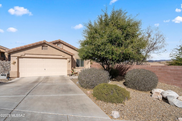 ranch-style home with driveway, a garage, a tile roof, fence, and stucco siding