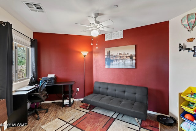 office with ceiling fan, wood finished floors, visible vents, and baseboards