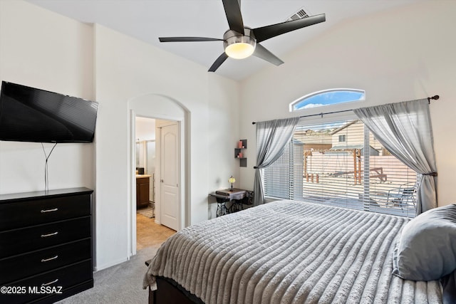 bedroom with lofted ceiling, ceiling fan, ensuite bath, and light colored carpet