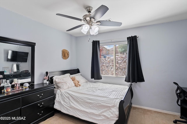 bedroom with light carpet, baseboards, and a ceiling fan