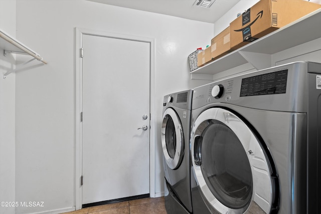 laundry room featuring laundry area, washer and clothes dryer, tile patterned flooring, and visible vents