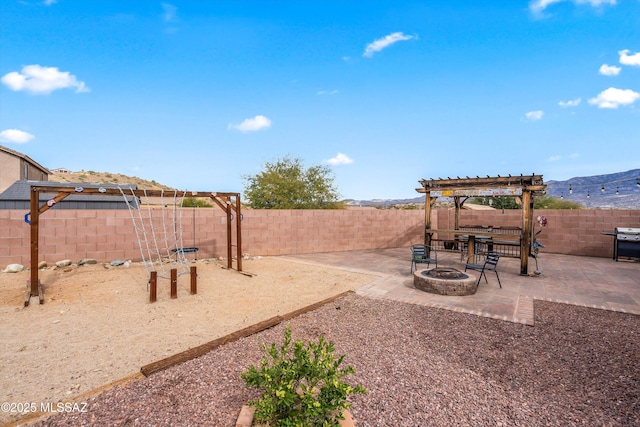 view of yard featuring a fire pit, a patio area, a fenced backyard, and a pergola