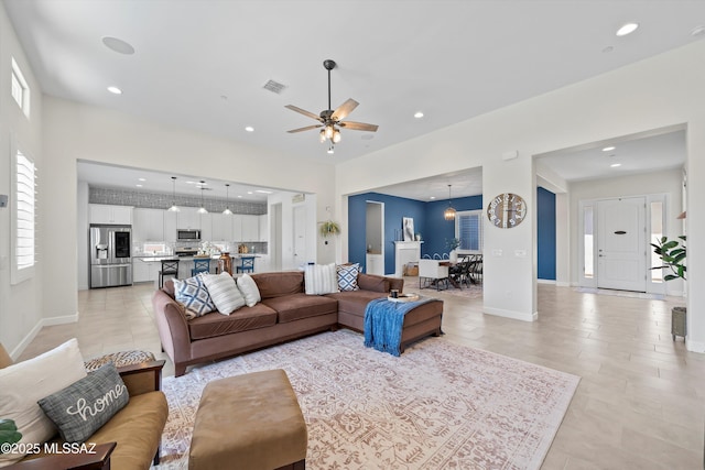 living room with baseboards, visible vents, recessed lighting, and ceiling fan