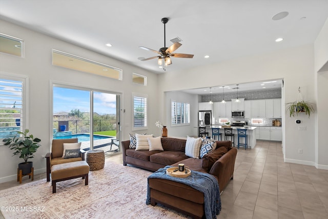 living room with light tile patterned floors, recessed lighting, and a healthy amount of sunlight