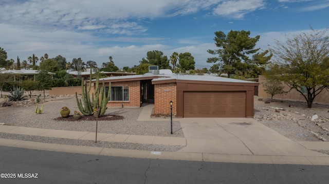 mid-century home featuring brick siding, driveway, and an attached garage