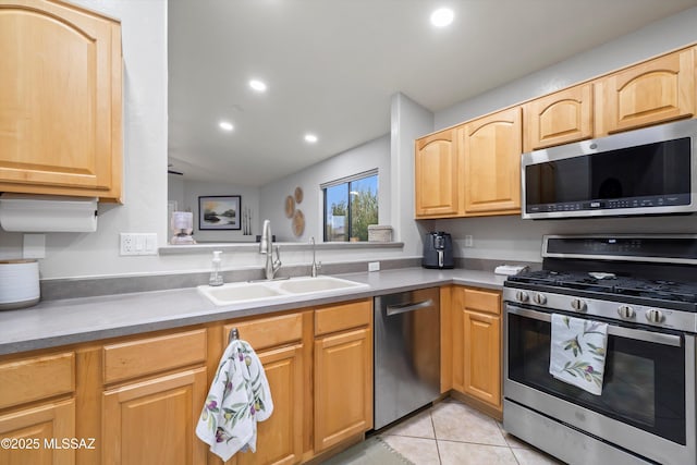 kitchen with light tile patterned flooring, a sink, recessed lighting, and stainless steel appliances