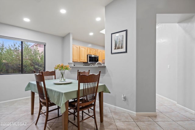 dining area featuring recessed lighting, light tile patterned floors, and baseboards