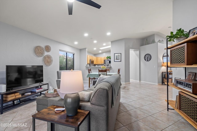 living area with light tile patterned floors, ceiling fan, recessed lighting, and lofted ceiling