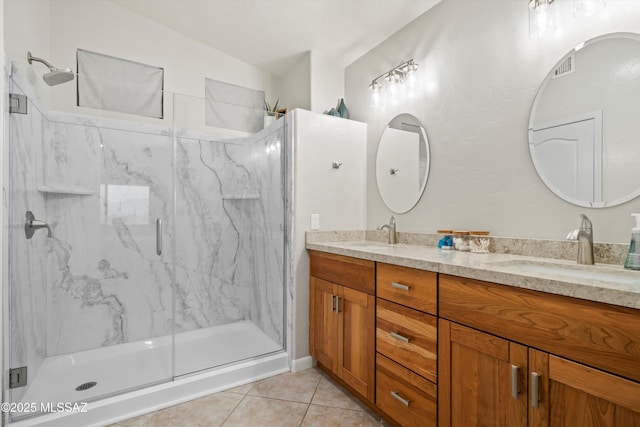 full bathroom with a sink, tile patterned floors, and a marble finish shower
