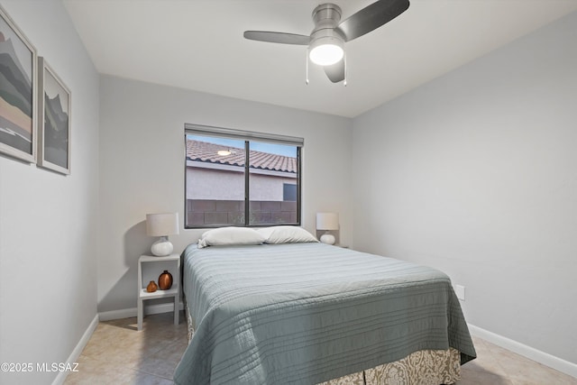 tiled bedroom featuring baseboards and ceiling fan
