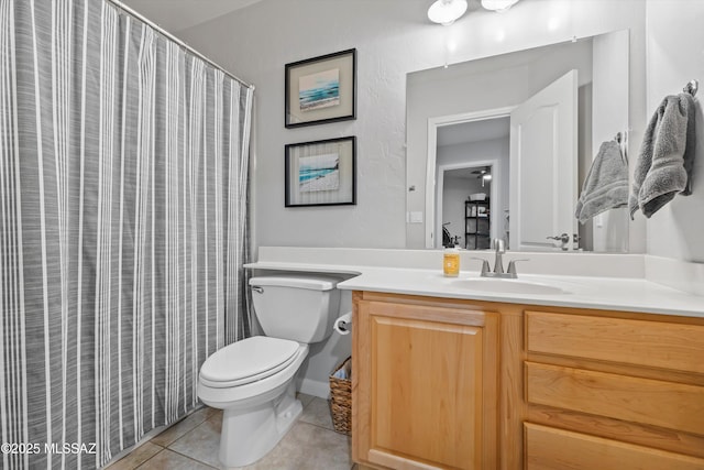 bathroom with toilet, vanity, a shower with shower curtain, and tile patterned flooring