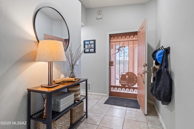 entrance foyer with light tile patterned floors, baseboards, and visible vents