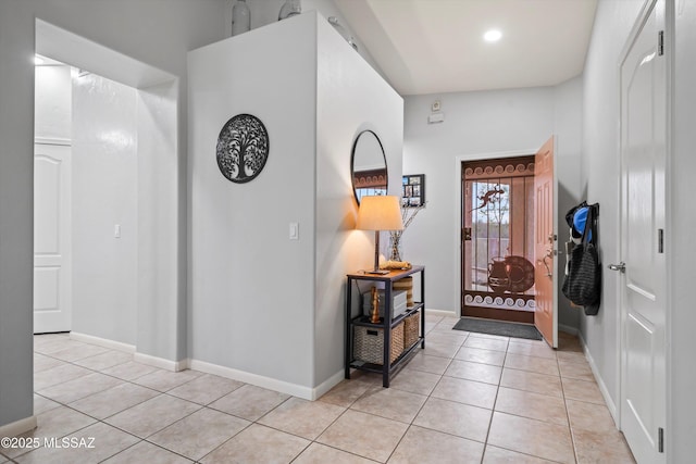 entryway with light tile patterned floors, baseboards, and recessed lighting