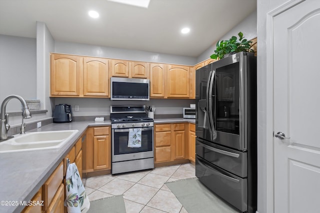 kitchen with recessed lighting, light tile patterned floors, a sink, and appliances with stainless steel finishes