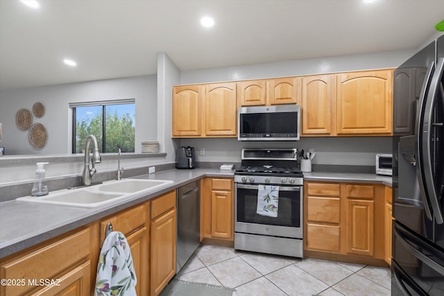 kitchen featuring appliances with stainless steel finishes, light tile patterned flooring, a sink, and recessed lighting