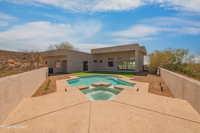 view of pool featuring a patio and an in ground hot tub