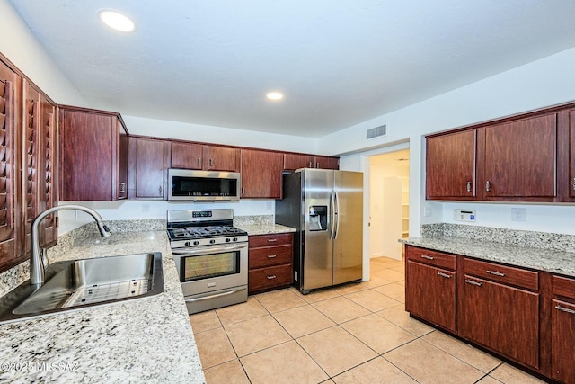kitchen with recessed lighting, light tile patterned floors, a sink, visible vents, and appliances with stainless steel finishes