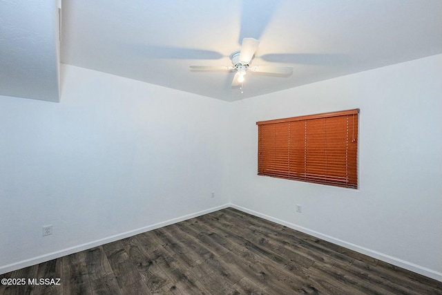 unfurnished room with baseboards, ceiling fan, and dark wood finished floors