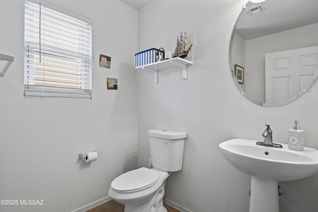 bathroom featuring sink and toilet