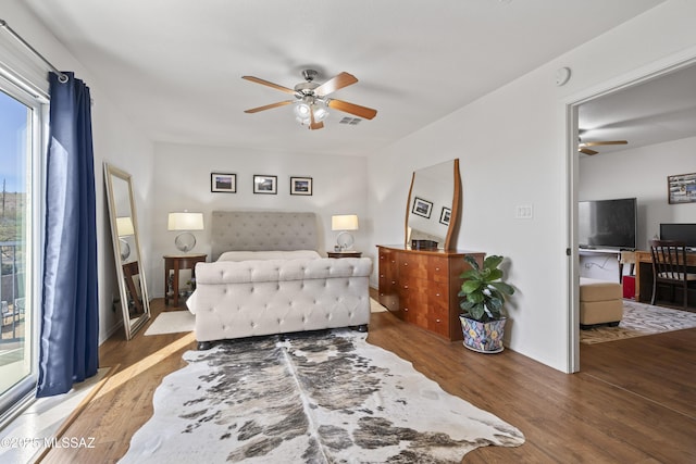 bedroom featuring ceiling fan and dark hardwood / wood-style floors