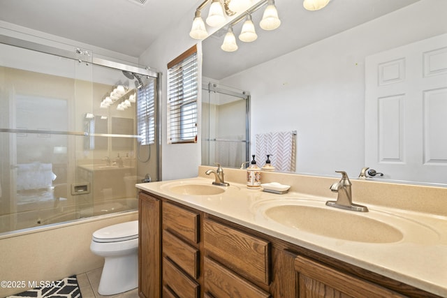 full bathroom with vanity, combined bath / shower with glass door, toilet, and tile patterned flooring