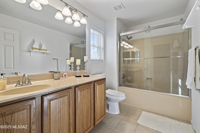 full bathroom featuring bath / shower combo with glass door, vanity, toilet, and tile patterned floors