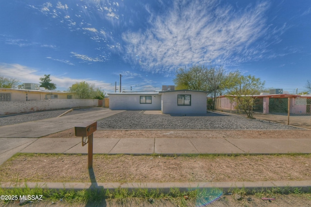 view of front of property with driveway and fence