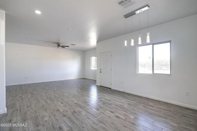 spare room with ceiling fan and wood-type flooring