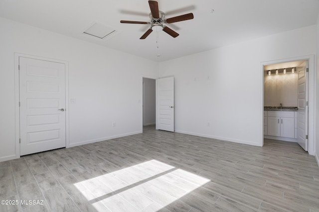 unfurnished bedroom featuring light hardwood / wood-style floors and ensuite bathroom