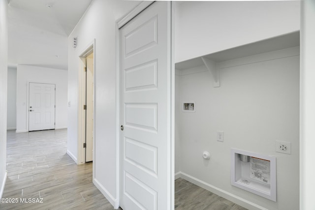 laundry room with hookup for a gas dryer, light hardwood / wood-style flooring, electric dryer hookup, and hookup for a washing machine