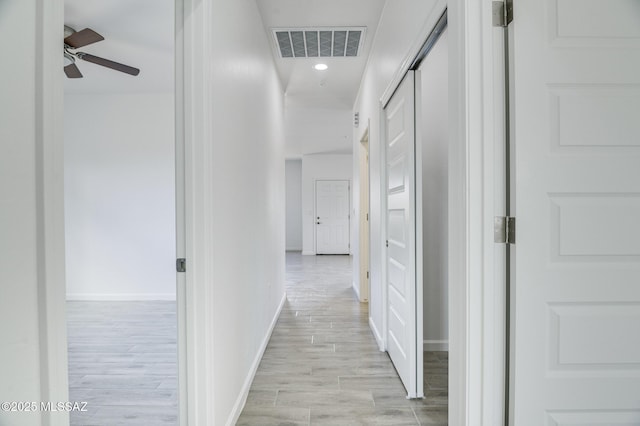 corridor featuring light hardwood / wood-style floors